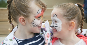 Two girls with face paint smiling