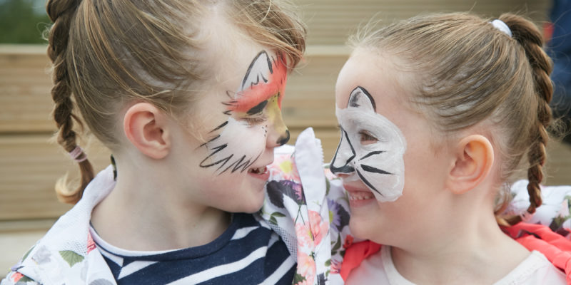 Two girls with face paint smiling