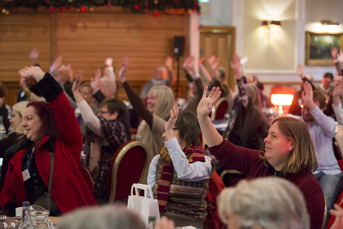 members with hands raised